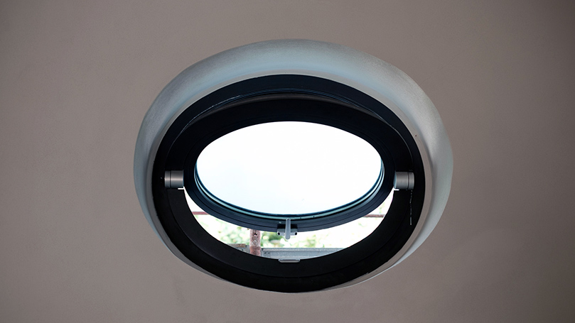 Curved or porthole windows in grey aluminium for renovation of classic and historical buildings and modern interiors.