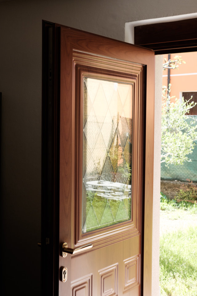 residential entrance door with rusticated panel and glass decoration produced and installed by aluser